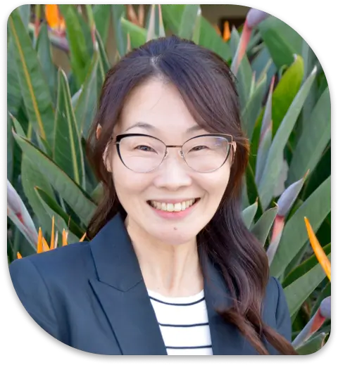 a close up of a woman wearing glasses and a suit