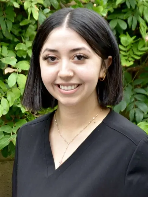 a close up of a woman in a black top smiling