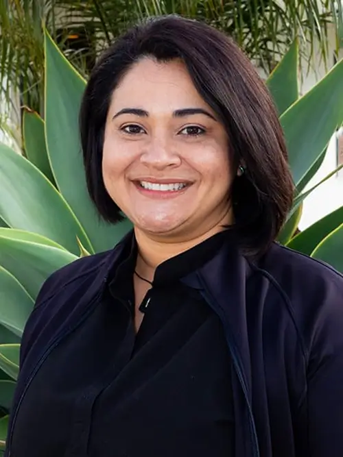 a close up of a woman in a black shirt smiling