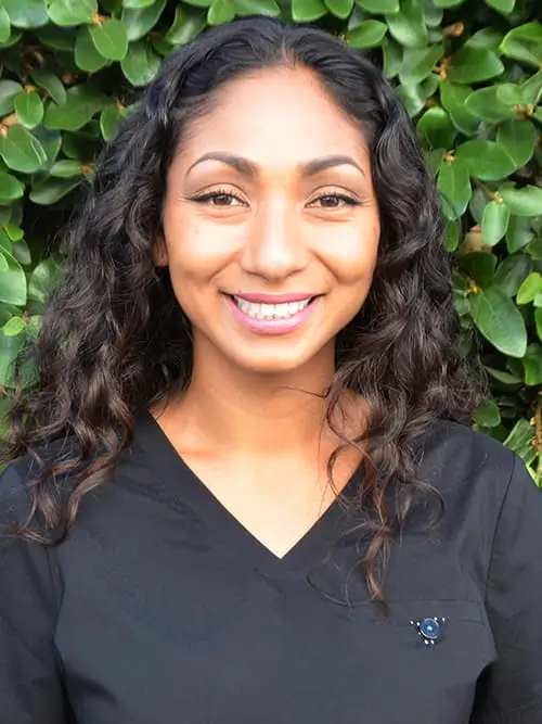 a close up of a woman with long hair smiling at the camera