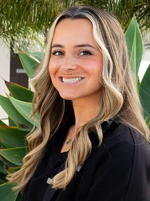 a close up of a woman with long hair and a black shirt